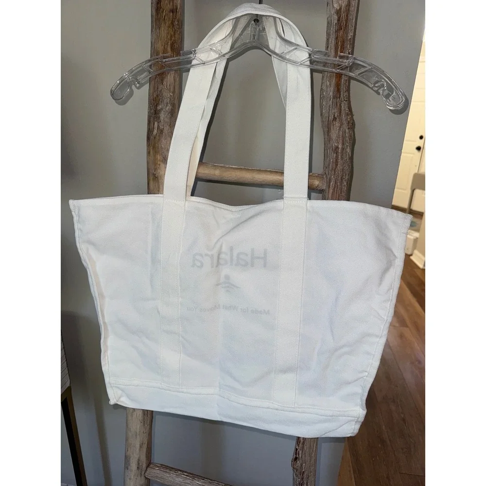 Women's white Halara canvas tote bag with a‎ green logo and text NWT travel gym